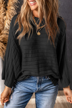 Dolman Pull in black ribbed knitting with exposed seams