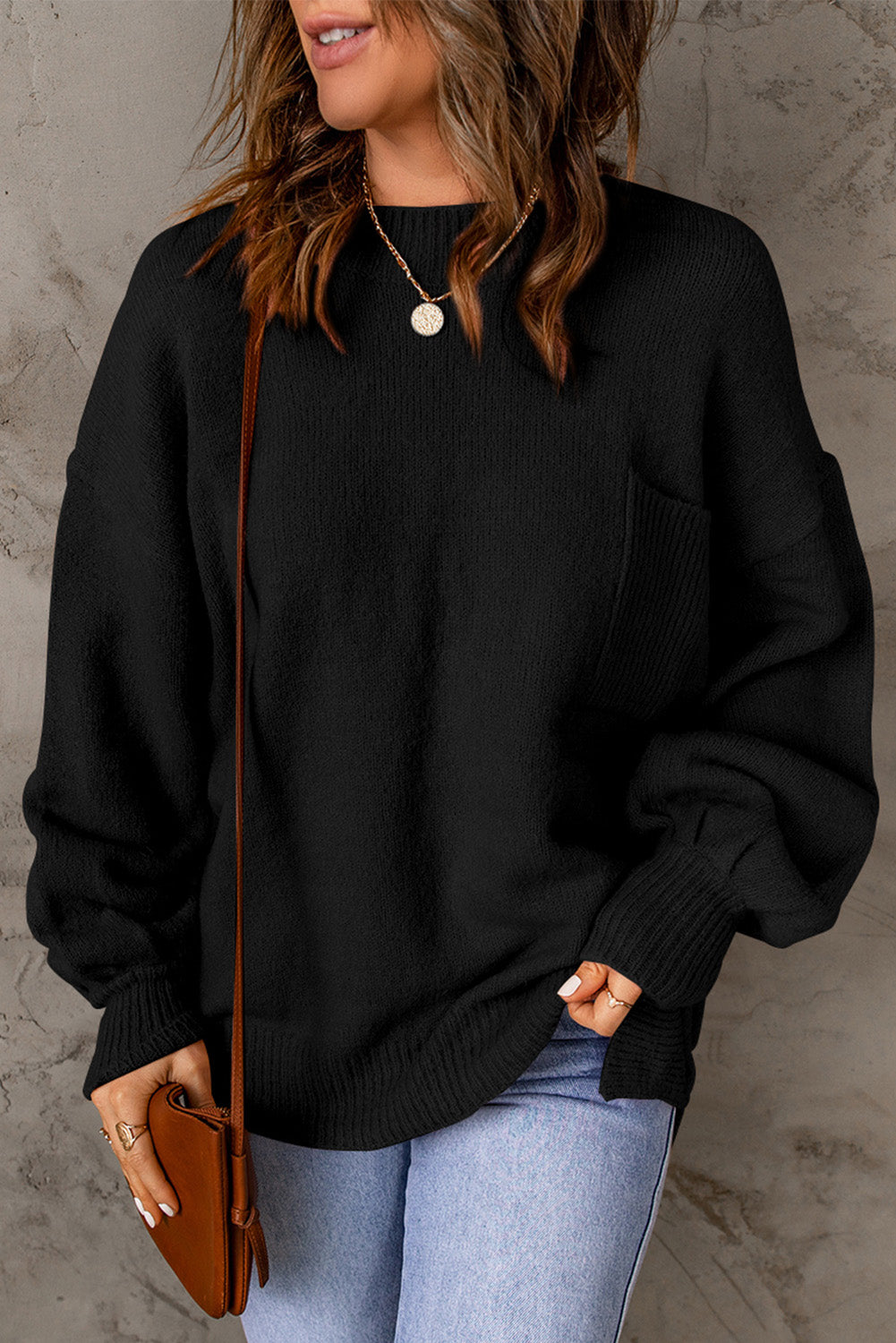 Black sweater with puff sleeves and solid color pockets