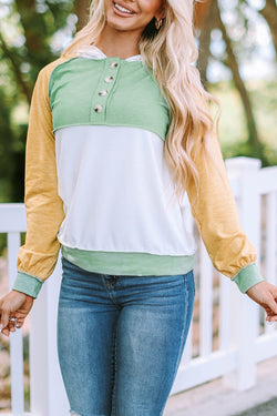 Yellow hoodie with color block buttons and accents