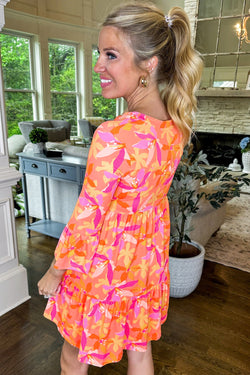 Orange dress with abstract print and ruffled sleeves, V-neck