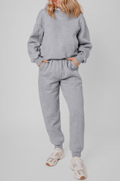 Set of plain gray sports clothing with hooded and jogging with exposed seams