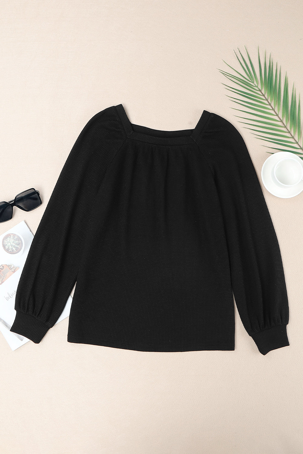 Black waffle knit top with puff sleeves and scoop neck