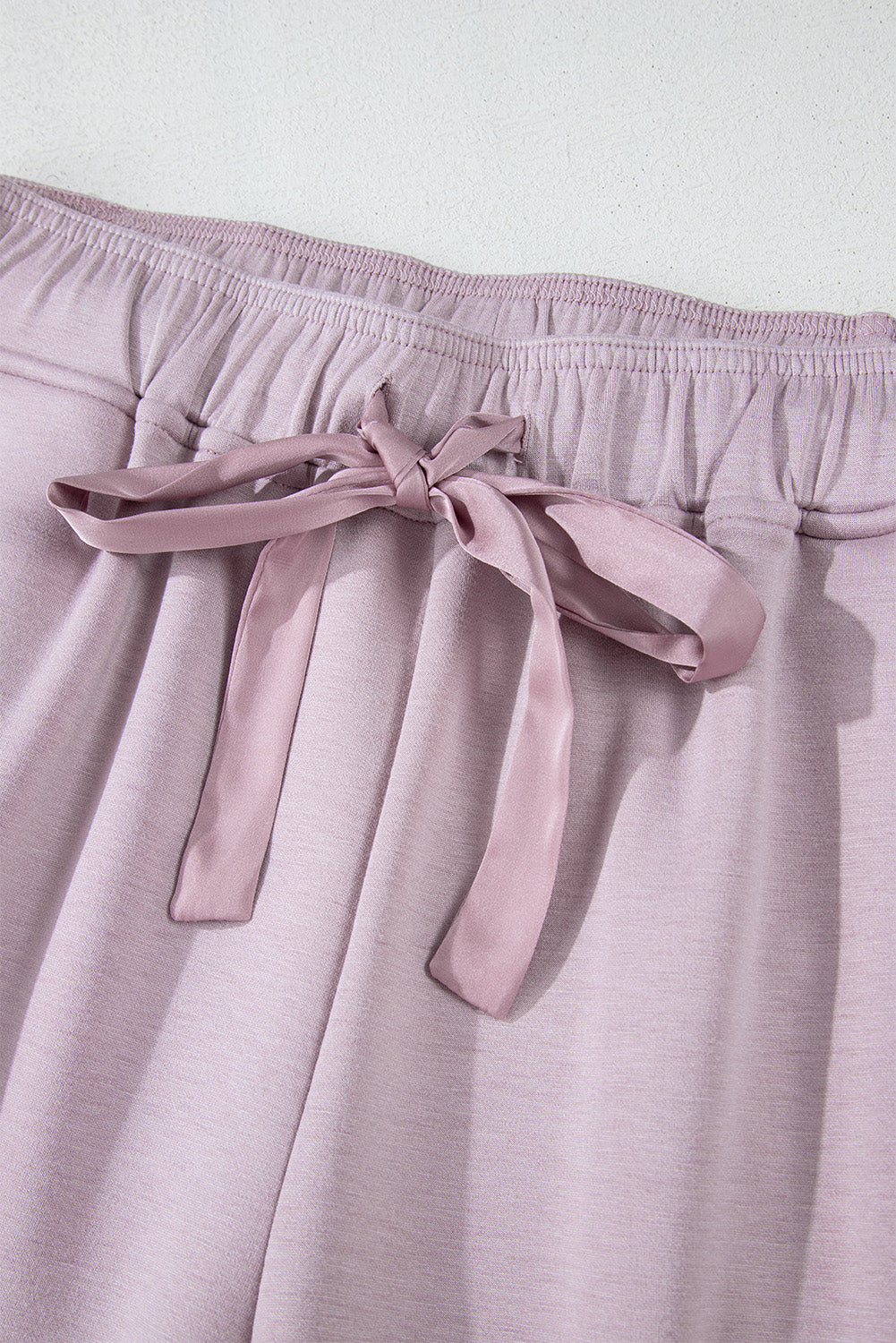 High waist pants with tightening cord and orchid petals, satin striped patch, right leg