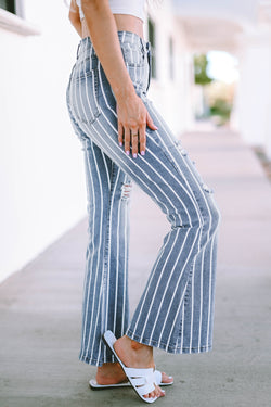 Flared jeans torn with vertical blue sky stripes