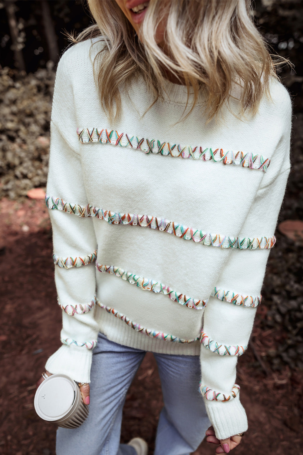 Colorful white sweater with dropped shoulders and crossed stitches