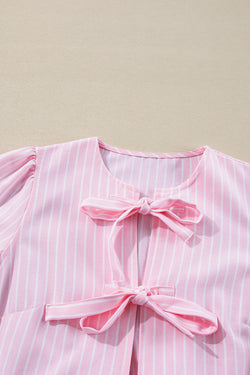 Striking pink blouse and bow tie on the front, round neck, puffy sleeves