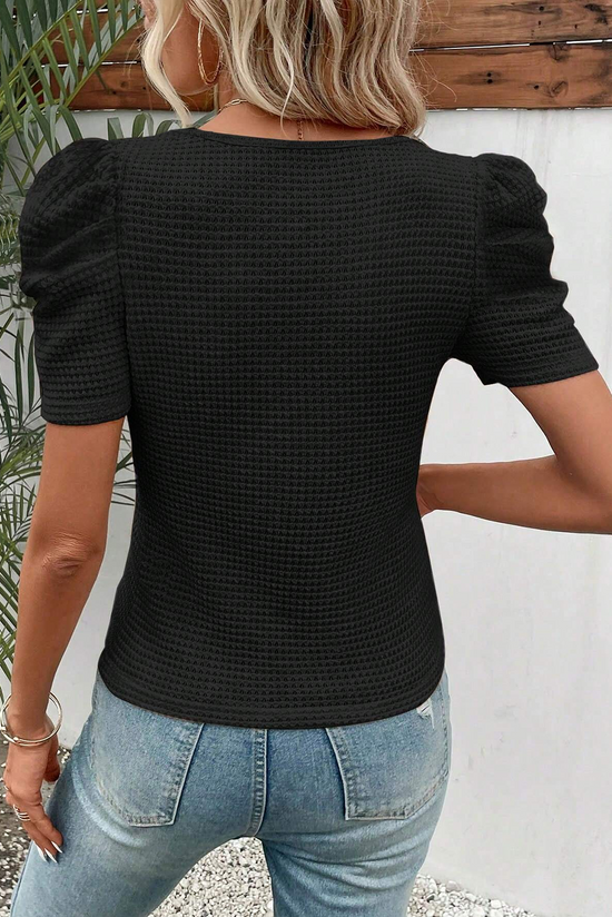 Black top with gathered puffy sleeves in embossed knitting