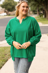 Bright green sweatshirt with exposed seams, notched collar and dropped shoulders