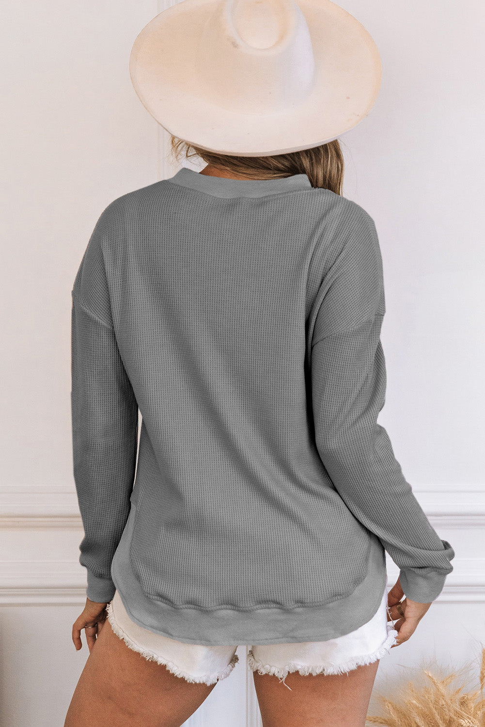 Grey waffle knit top with ribbed trim and crew neck