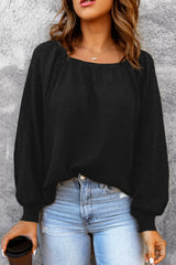 Black waffle knit top with puff sleeves and scoop neck