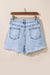 Light blue acid washed raw edge crossover denim shorts