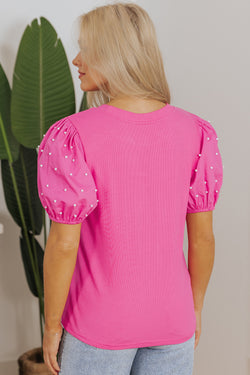 Bright ribbed pink with puffy sleeves and pearls *