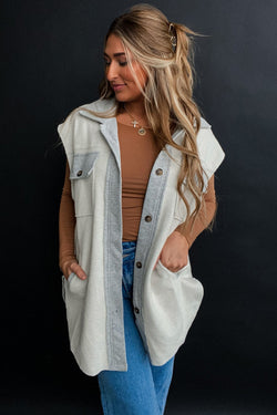 Light grey jacket with flap pockets and contrasting buttons on the front