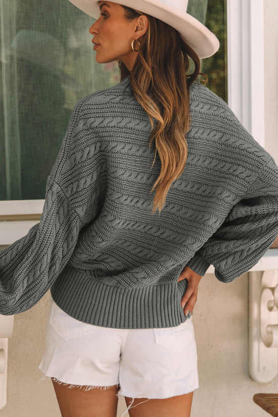 Gray cable knit sweater with lantern sleeves and high neck