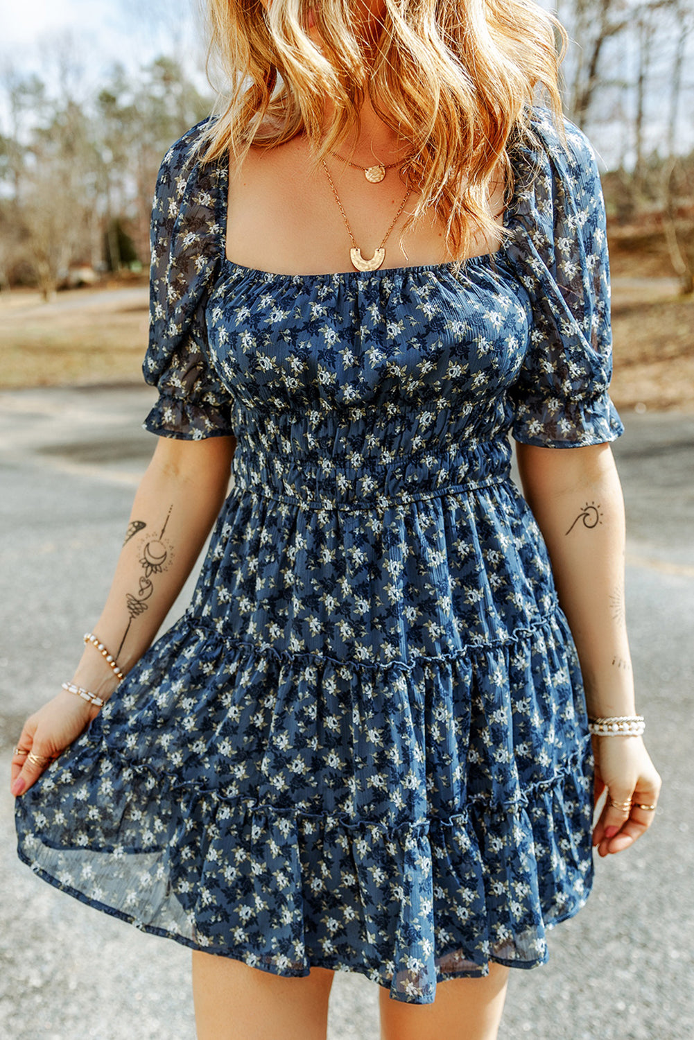 Short dress with ruffles and floral smocking in voile blue