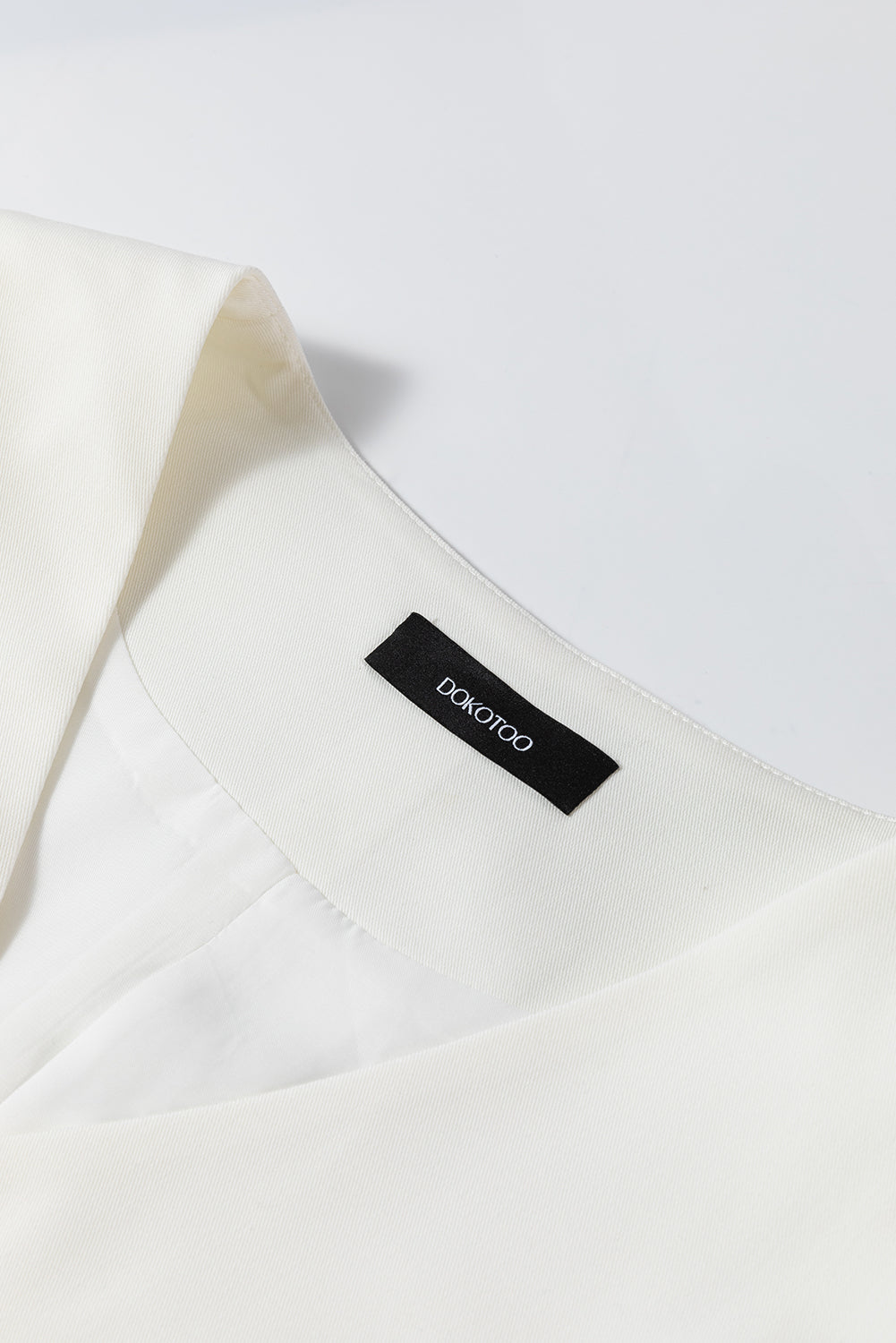 White costume vest with united buttoned V -neck colored