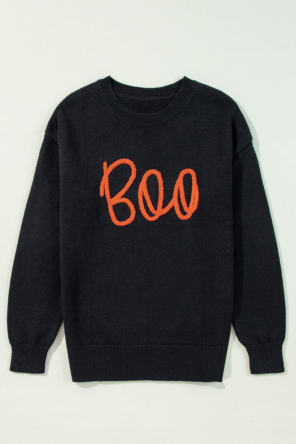 Black sweater with drooping shoulders and ribbed edges with Boo knitted pattern