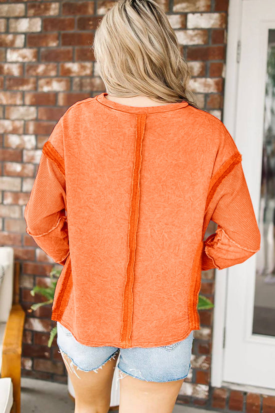 Orange raw edge sweatshirt with exposed seams, top and bottom