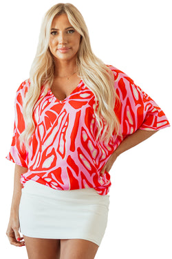 Oversize red blouse with abstract print, V-neck, bat handles