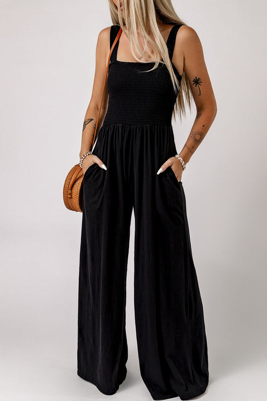 Black sleeveless smocked wide leg jumpsuit with pockets