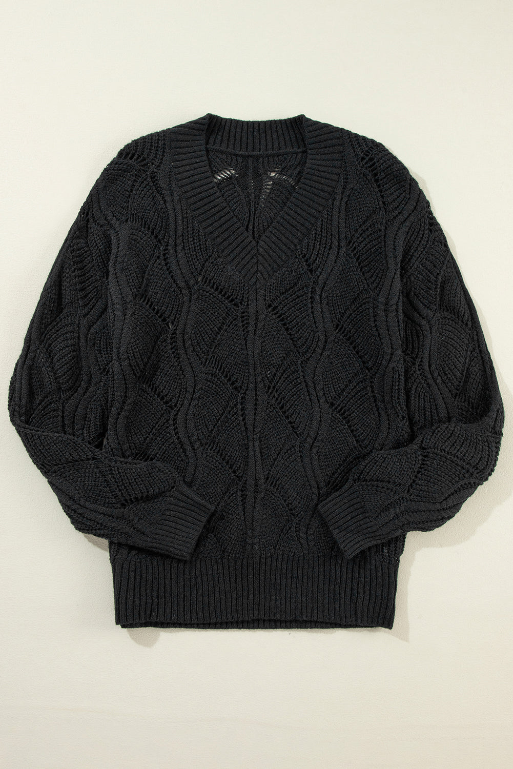 Black openwork knit sweater with V-neck and dropped shoulders