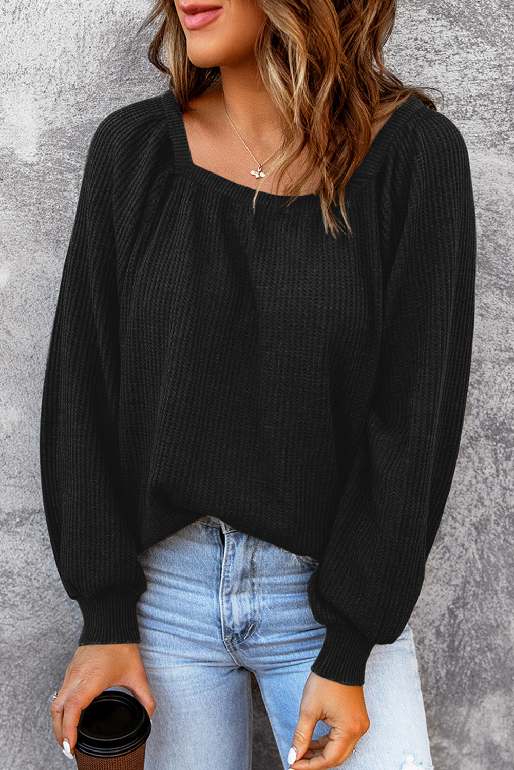 Black waffle knit top with puff sleeves and scoop neck