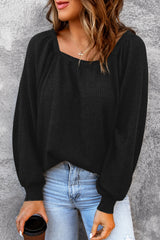 Black waffle knit top with puff sleeves and scoop neck