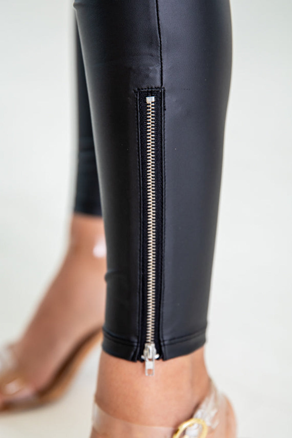 Black faux leather leggings with zip detail