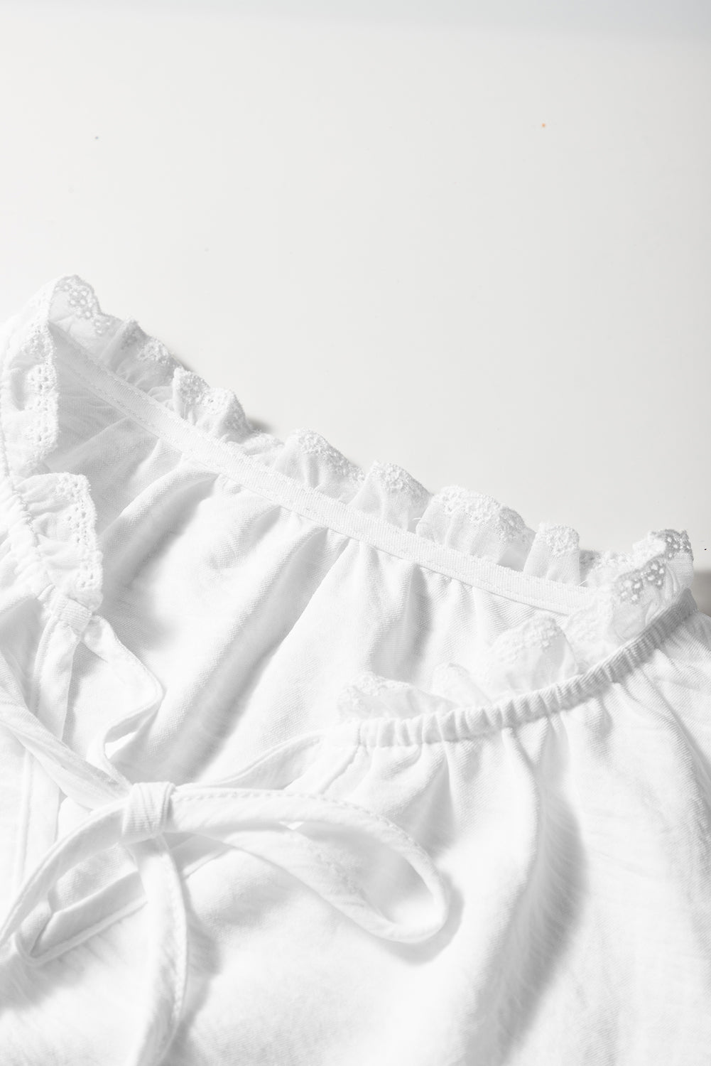 White textured blouse with embroidered ruffles *