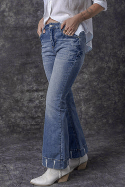 Lightly distressed sky blue flared jeans with a medium wash