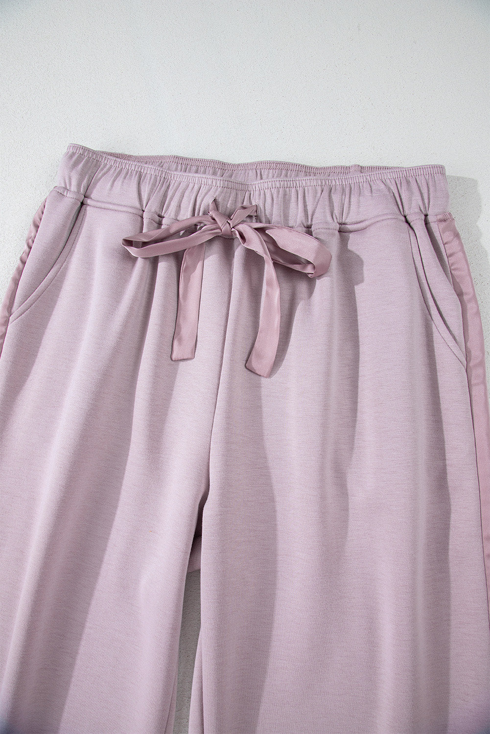 High waist pants with tightening cord and orchid petals, satin striped patch, right leg