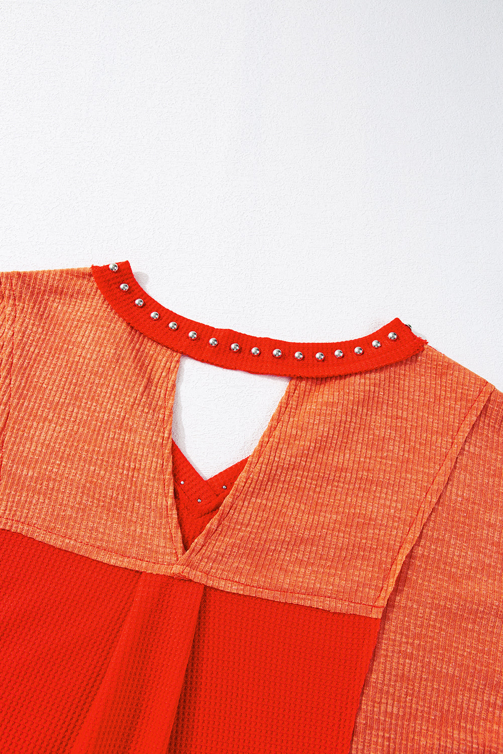 Fiery Red Studded V Neckline Exposed Seam Textured Knit Top