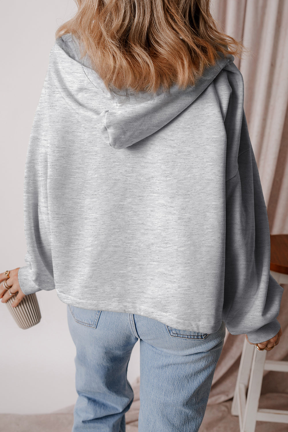 Light grey loose hoodie with half zip and fleece-lined kangaroo pockets