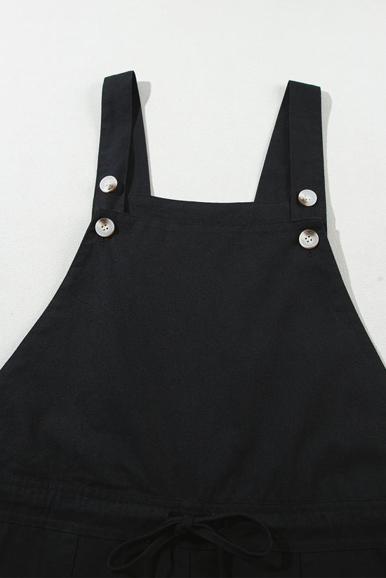 Black short overalls with buttoned straps and drawstring