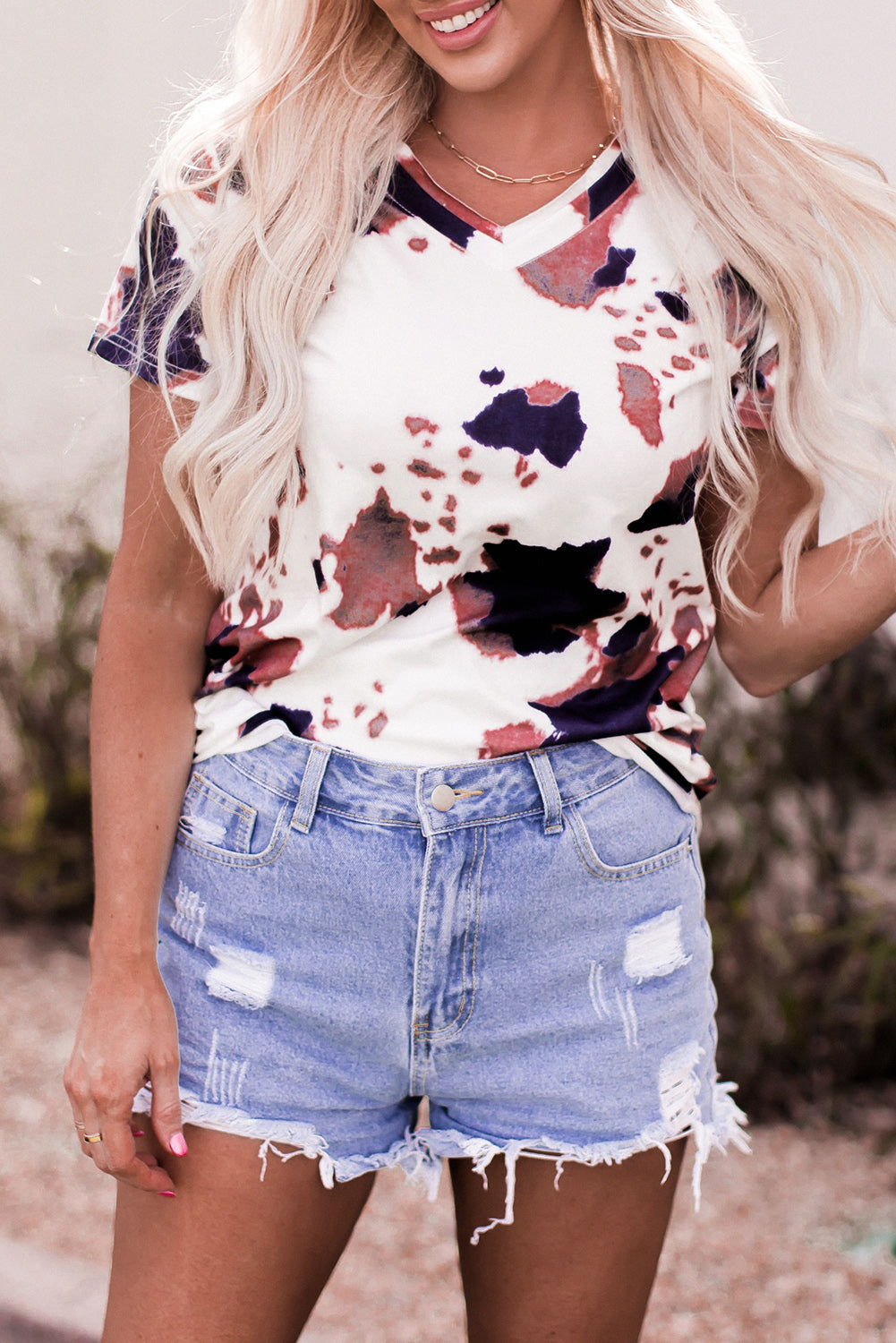White T-shirt with short sleeves and V-neck printed with cow pattern