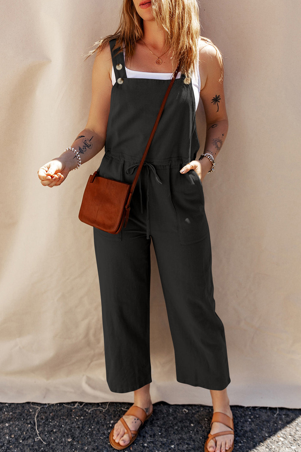 Black short overalls with buttoned straps and drawstring