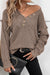 Khaki tricot sweater buttoned with V -neck button and drooping shoulders