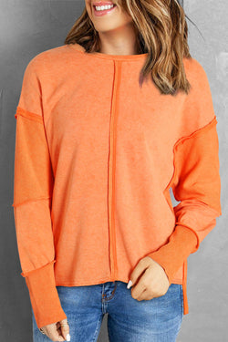 Orange raw edge sweatshirt with exposed seams, top and bottom