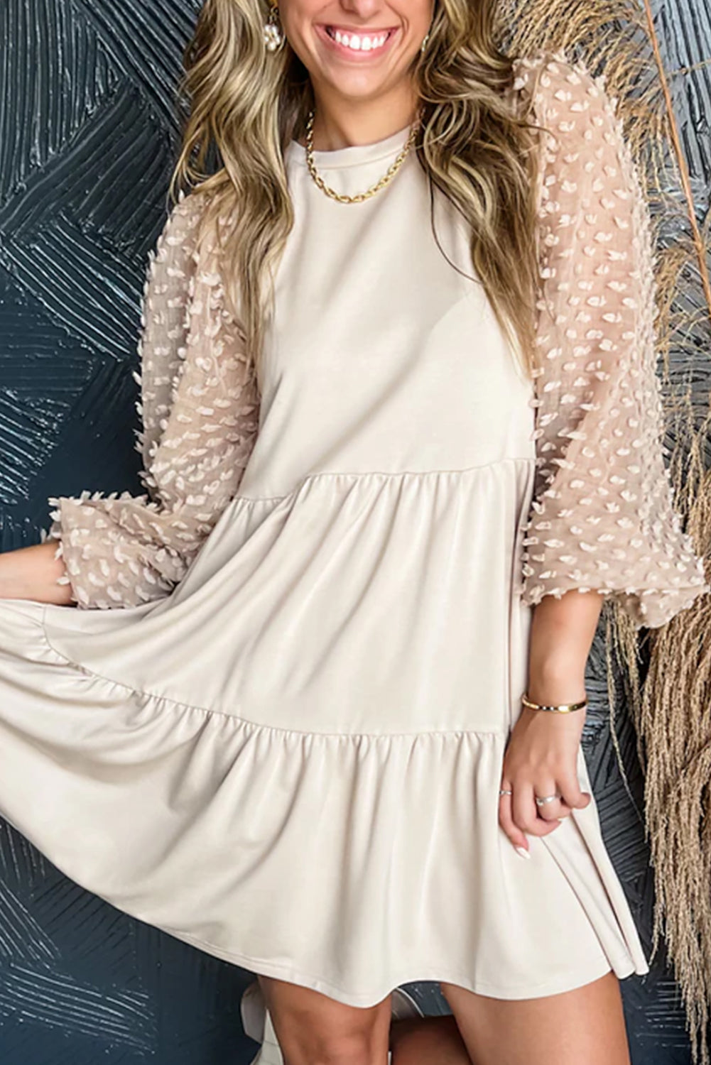 Beige trapeze dress adorned with puffy sleeves and several levels