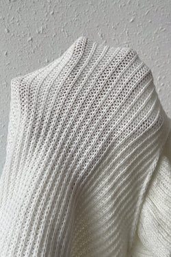 White ruffled sweater in twisted knitting with short sleeves and turtlenecks