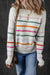 White sweater with colored stripes and ribbed borders