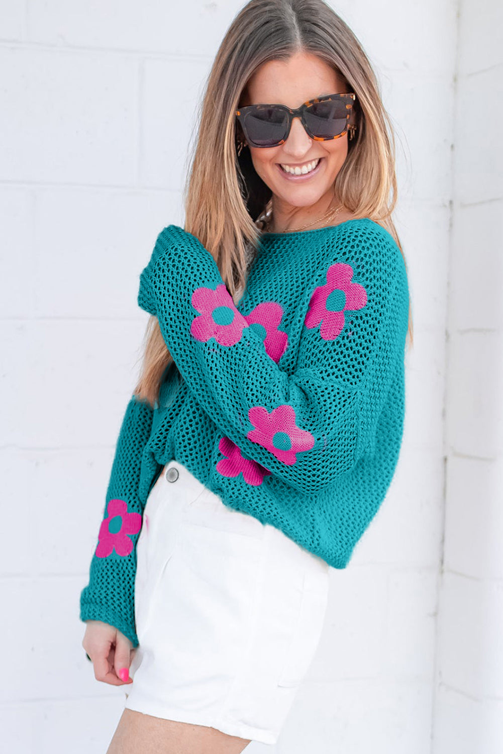 Dropped shoulder sweater in openwork knit with large sea green flower