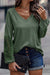 Green top with raglan sleeves and crochet lace patch