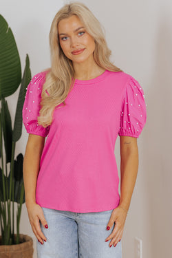 Bright ribbed pink with puffy sleeves and pearls *