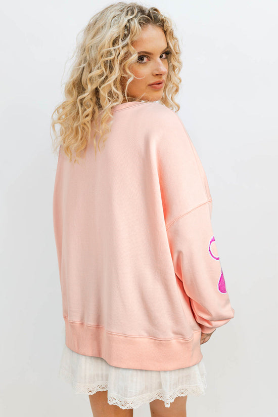 Sudadera de albaricoque rosa de gran tamaño con brillo y nudo de mariposa caída