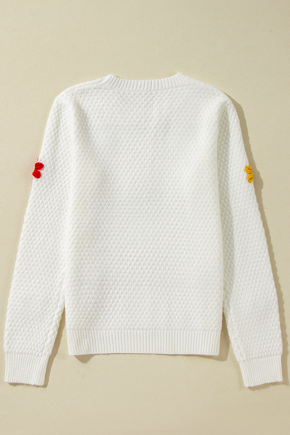 Textured knit sweater with white colorful flower appliques