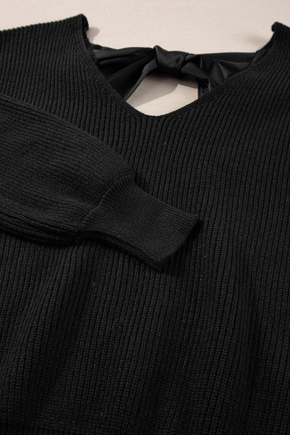 Black sweater with lantern sleeves, V-neck, knot at the back