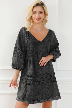 Black pleated denim babydoll dress with v-neck and puff sleeves