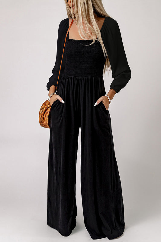 Black smocked jumpsuit with square neck, long sleeves, wide leg