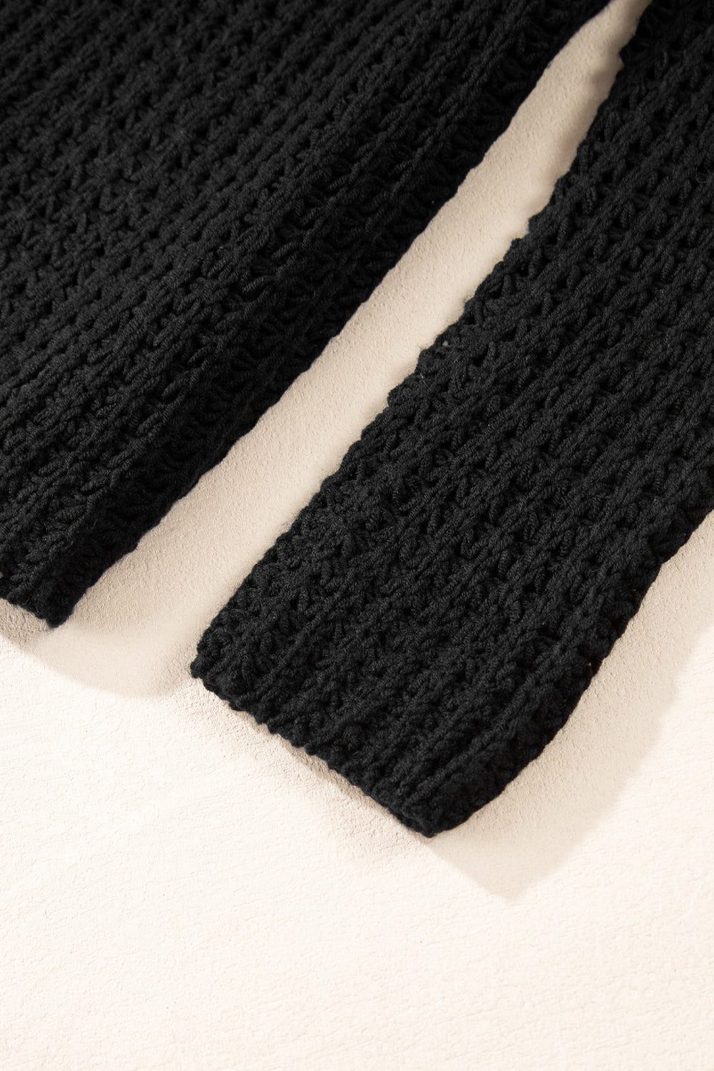 Black V-neck sweater with openwork crochet